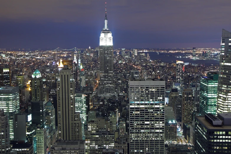 the empire state building lit up at night