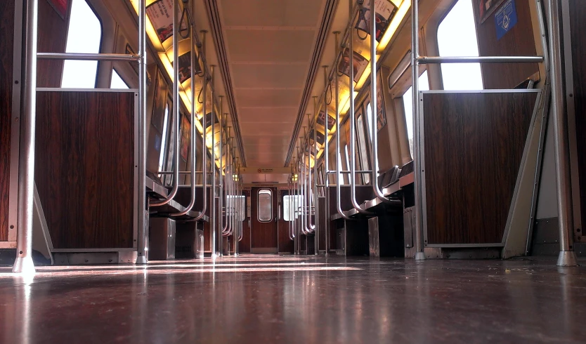 rows of brown and white chairs on either side of a metal hallway