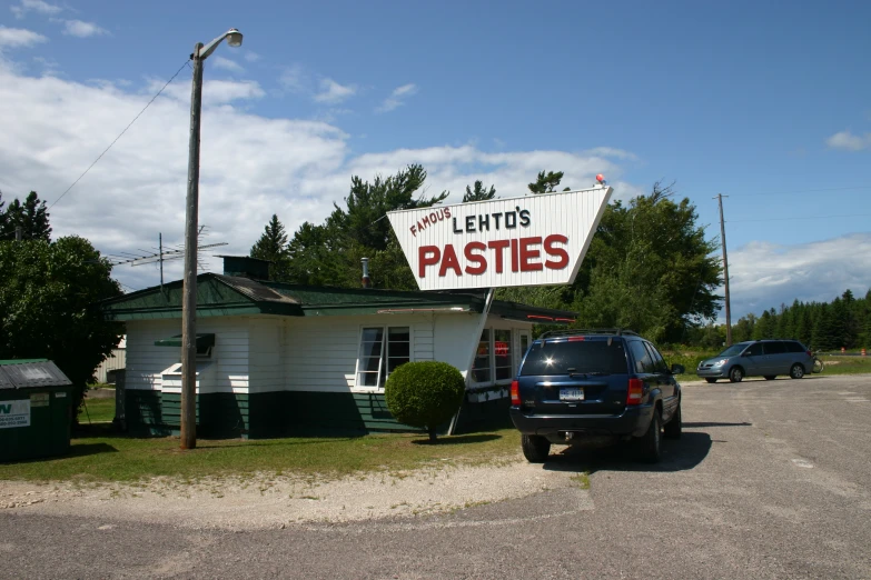 a sign for plenty's pastes in front of a building