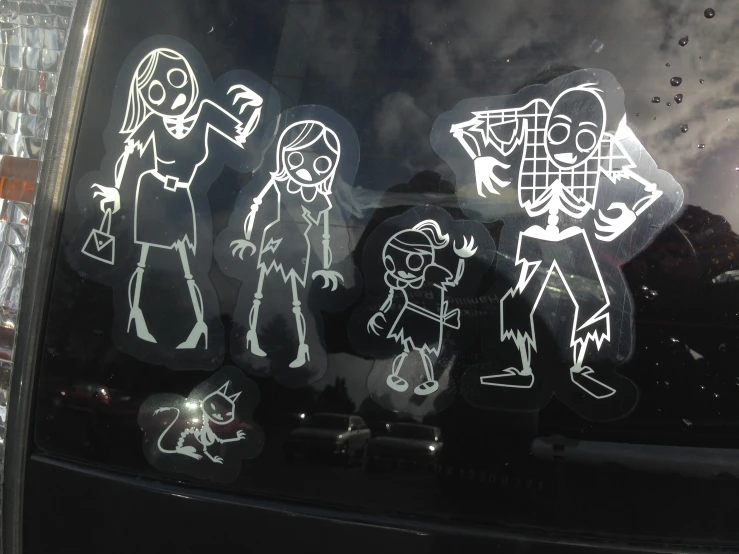an image of children with ghost cut out on the back window