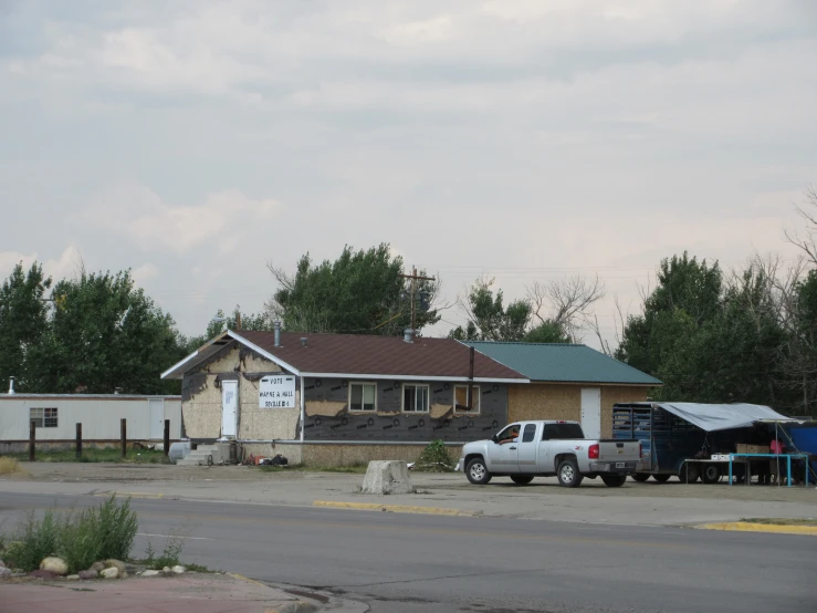 the two trucks are parked outside the shop