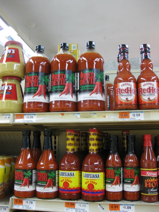 the chili sauces are for sale in a store