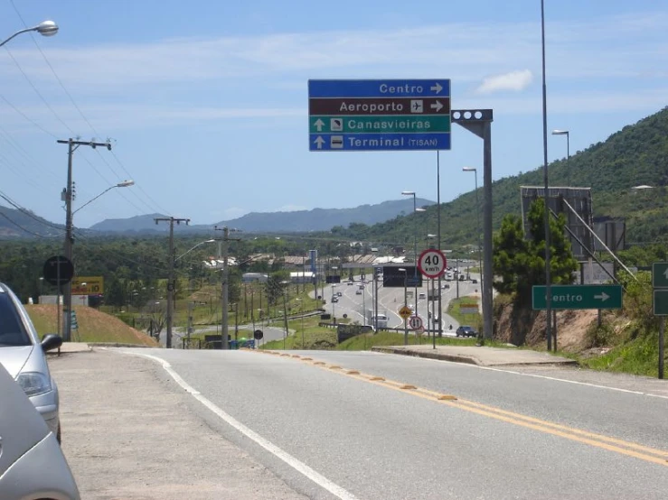 there is a blue and white sign pointing the way to destinations