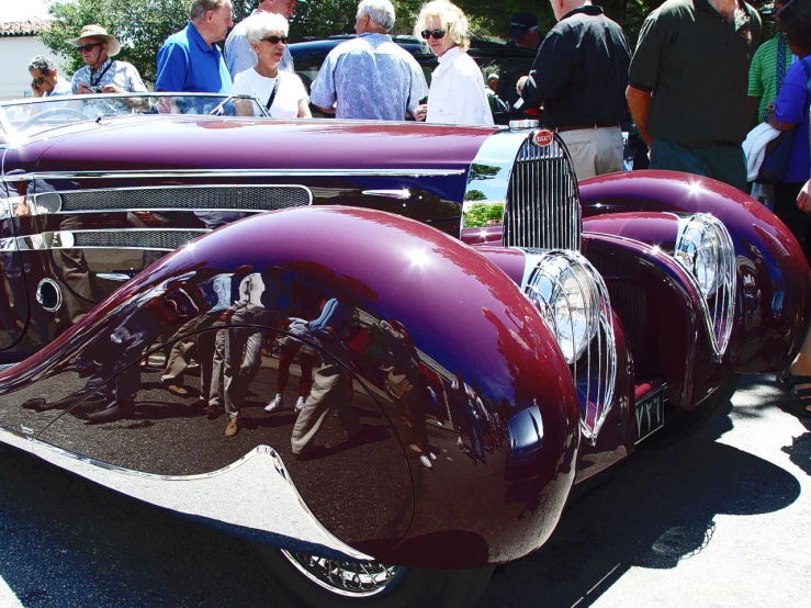 an antique  rod at a car show