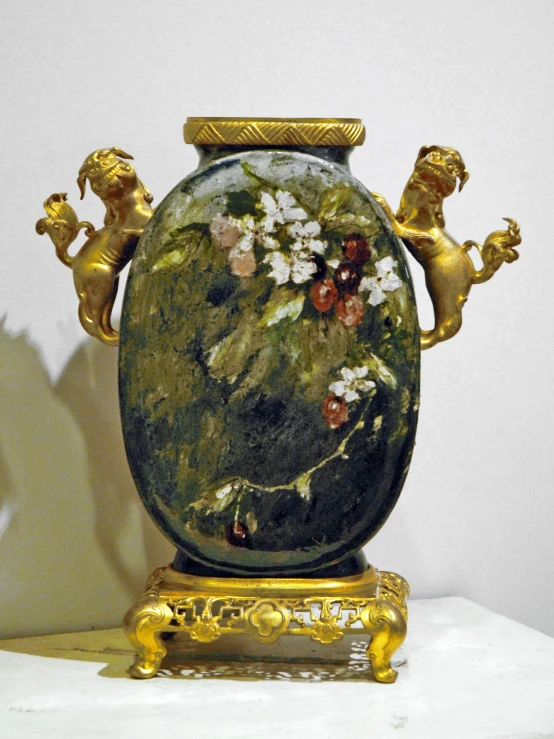 a large vase with a painted gold lion motif