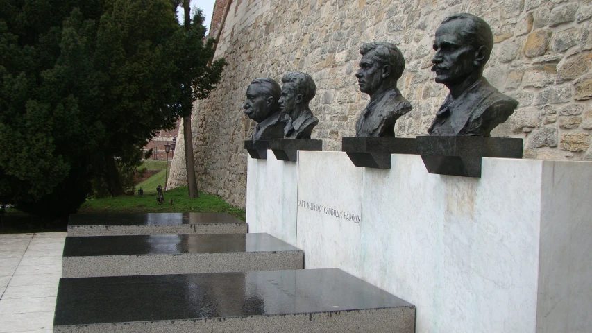 a row of marble busts with writing on them