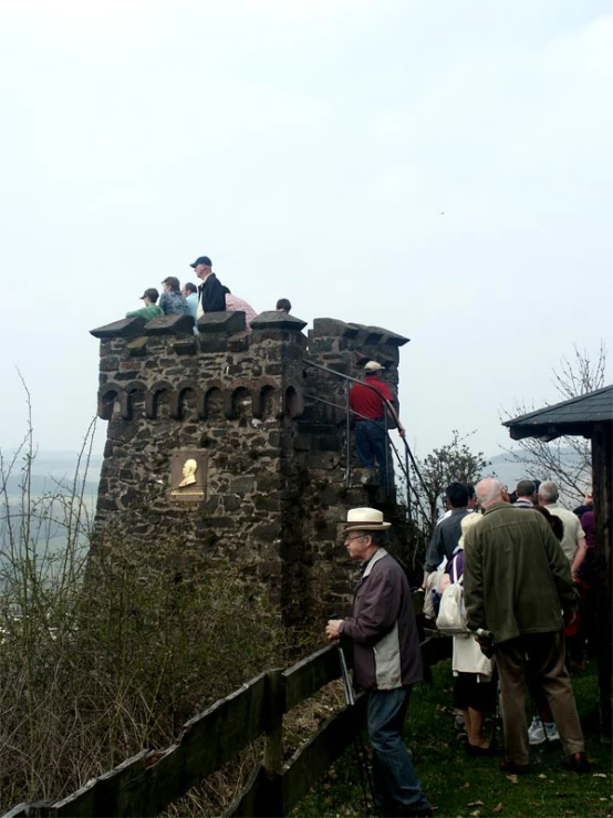 people walking up to the top of a stone tower