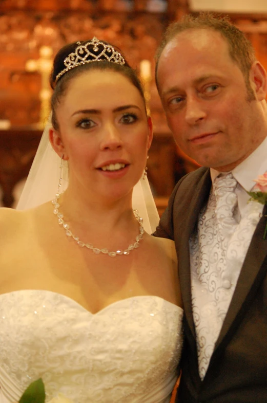 a couple posing for the camera in a church