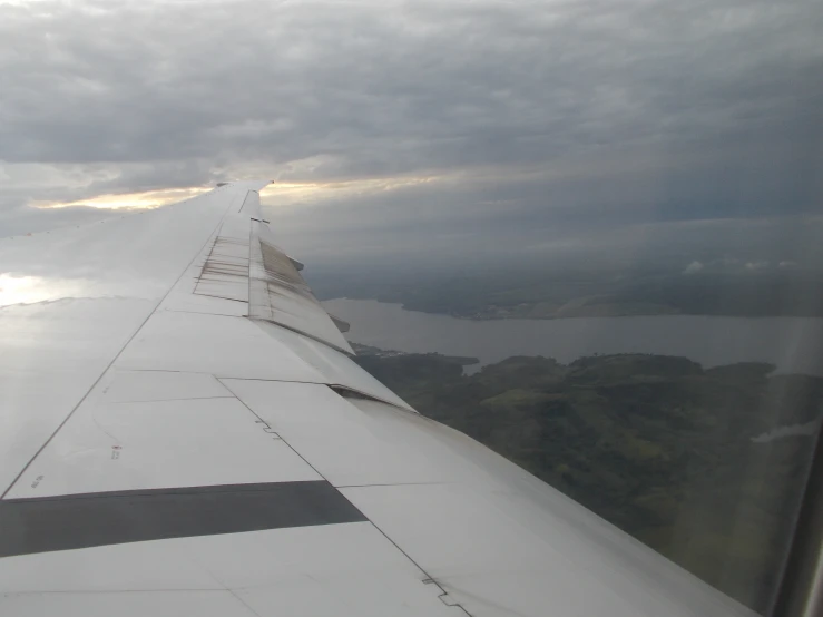 the view out an airplane window with wing extended