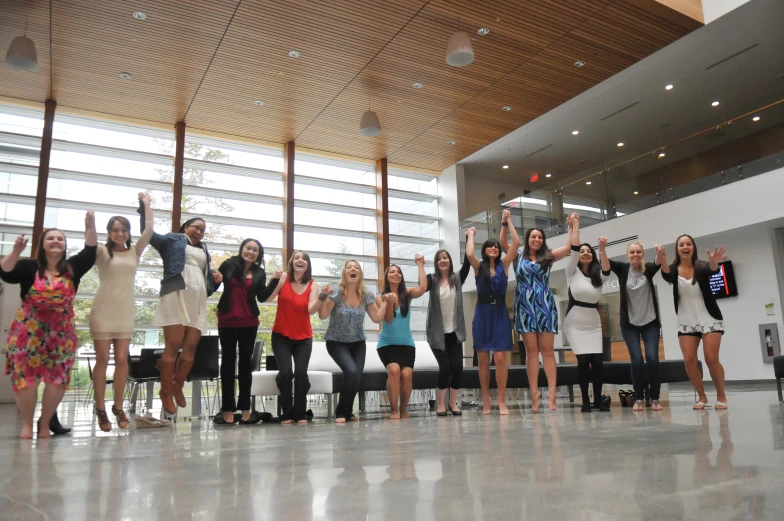 several women in dress clothes are taking pictures