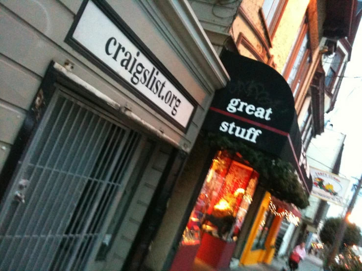 store signs advertising food and shops on a city street