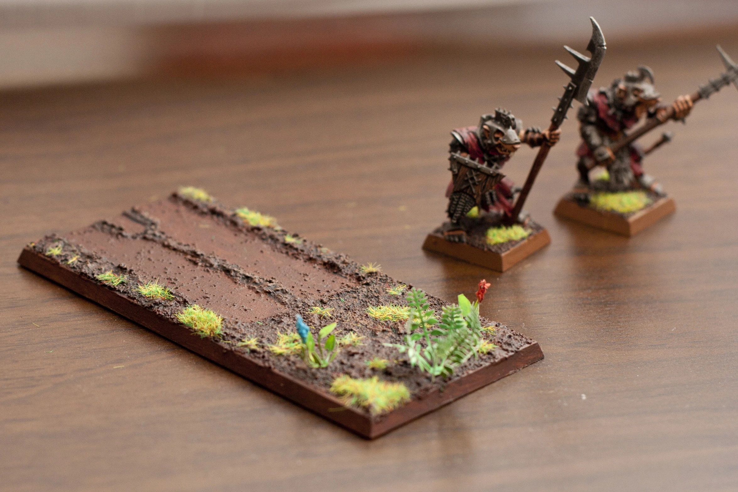 a wooden table with two figures holding swords