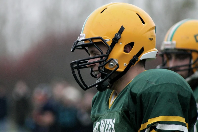 two football players with helmets on during a game