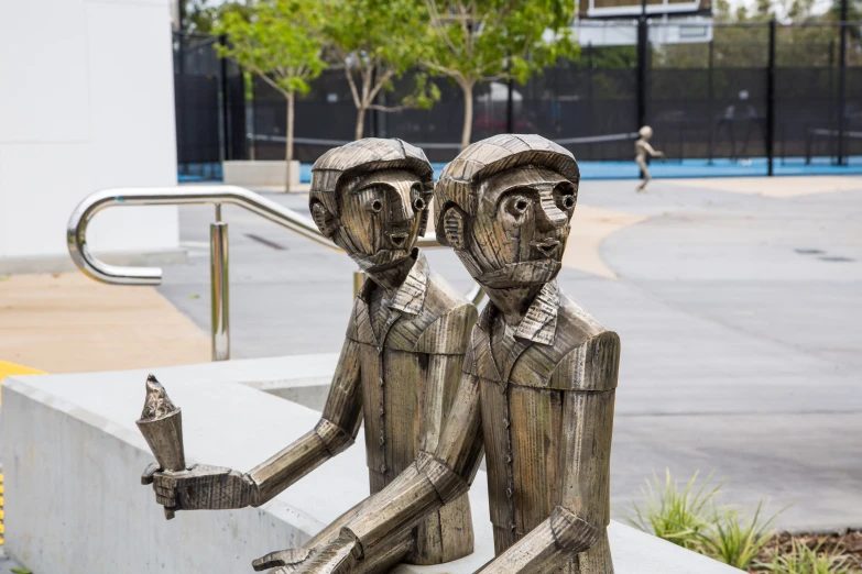 two statues are holding hands while they're looking at each other