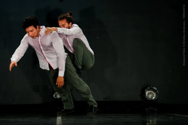 two people in formal dress are doing some tricks