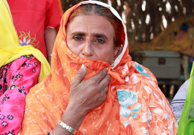 a woman is dressed in brightly colored clothing and jewelry