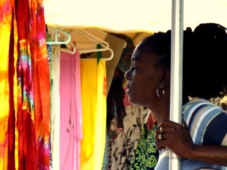 there is a woman that is browsing the store's clothing