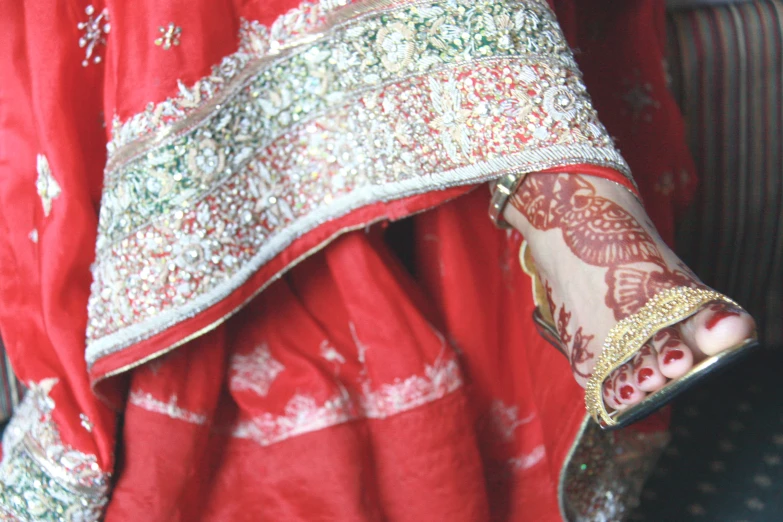 an indian style red dress has gold detailing