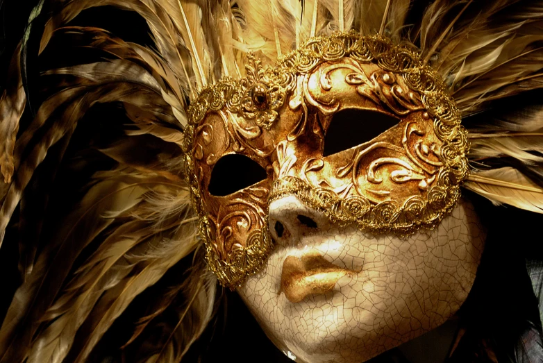 a close up of a person wearing a gold mask