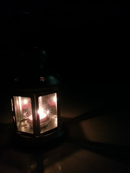 a lantern lit in the dark by some kind of light