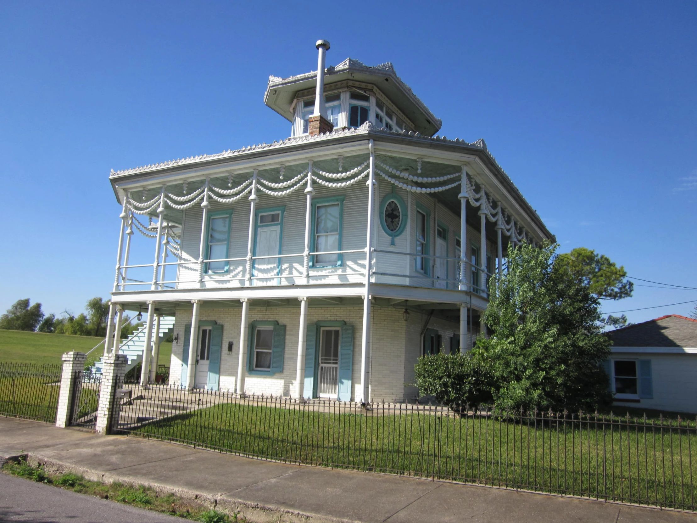 a tall victorian house on the side of the road