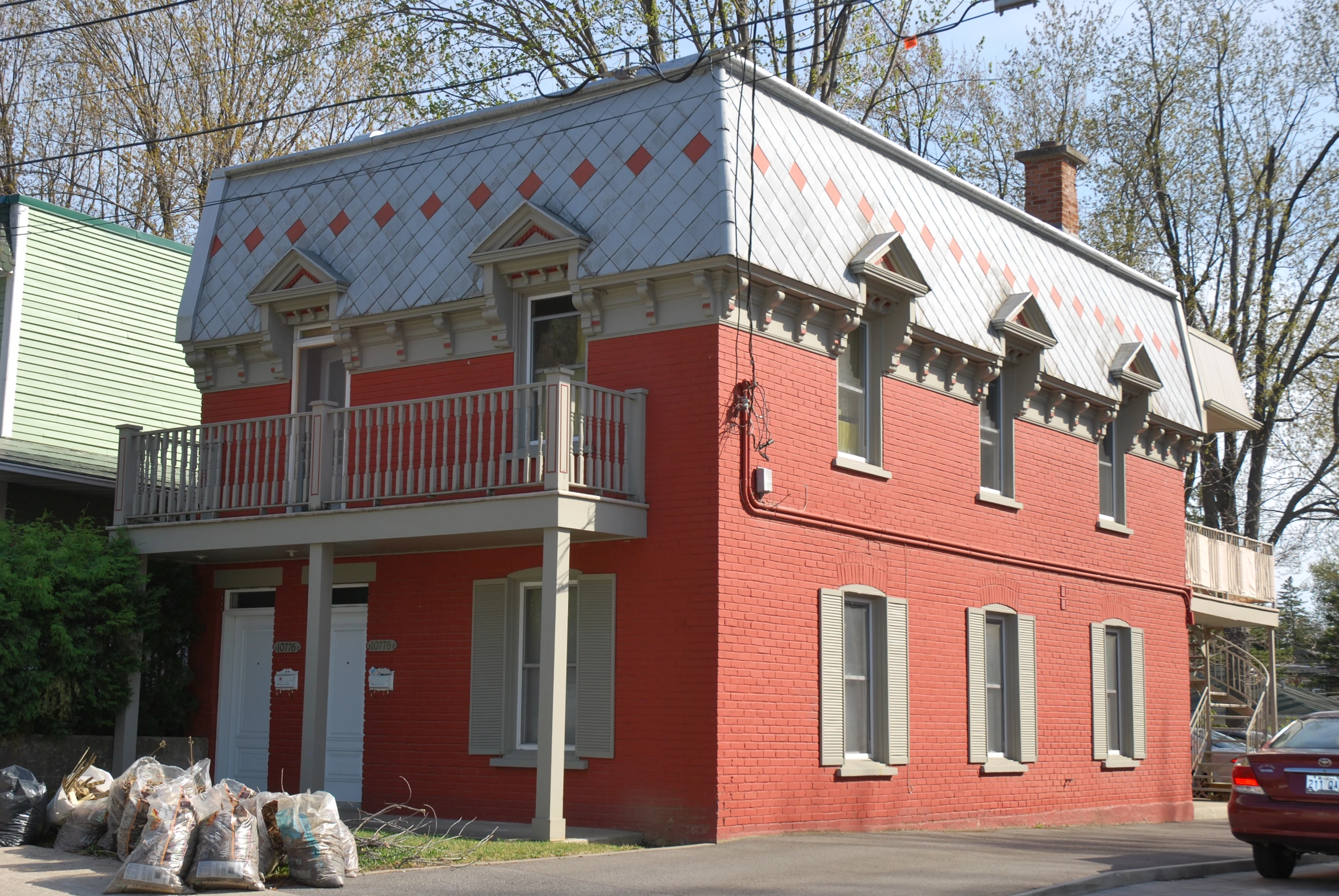 two brick houses with balconies and a balcony