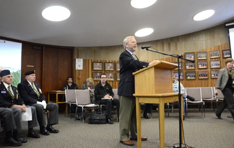 a man standing at a podium giving a speech