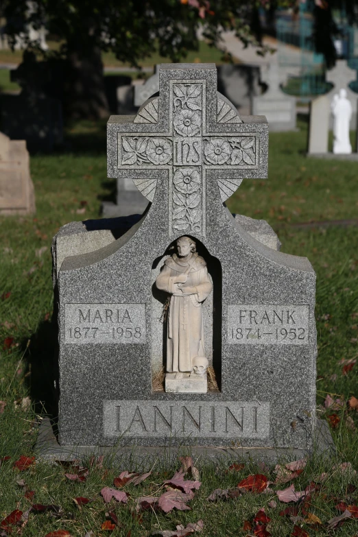 a grave with a carved religious figure inside