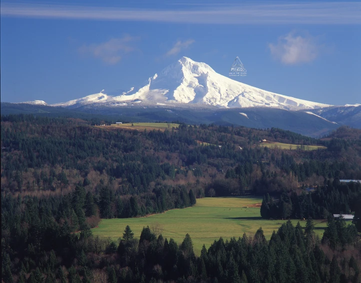 there is a large mountain range covered in snow