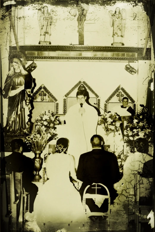 a couple are sitting in front of a black and white po