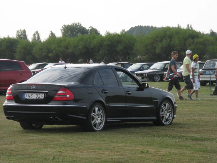 there are many cars parked at the event