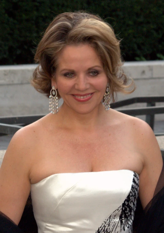 a woman posing for a picture in a white dress