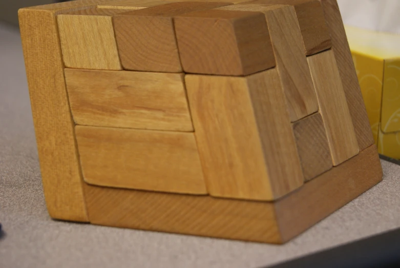 a small wooden cube on top of some kind of table