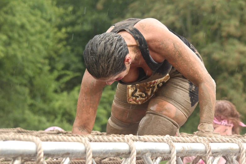 a man bending over holding a rope rope