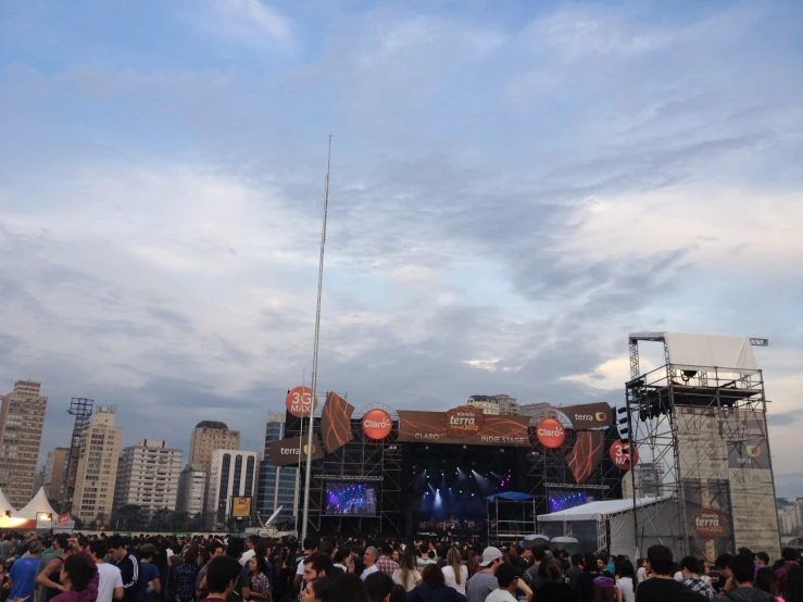 a concert scene with an array of speakers and band