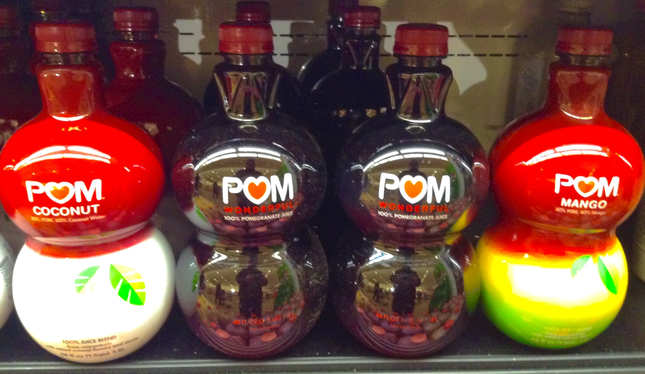 several poom cocktails on a refrigerator shelf