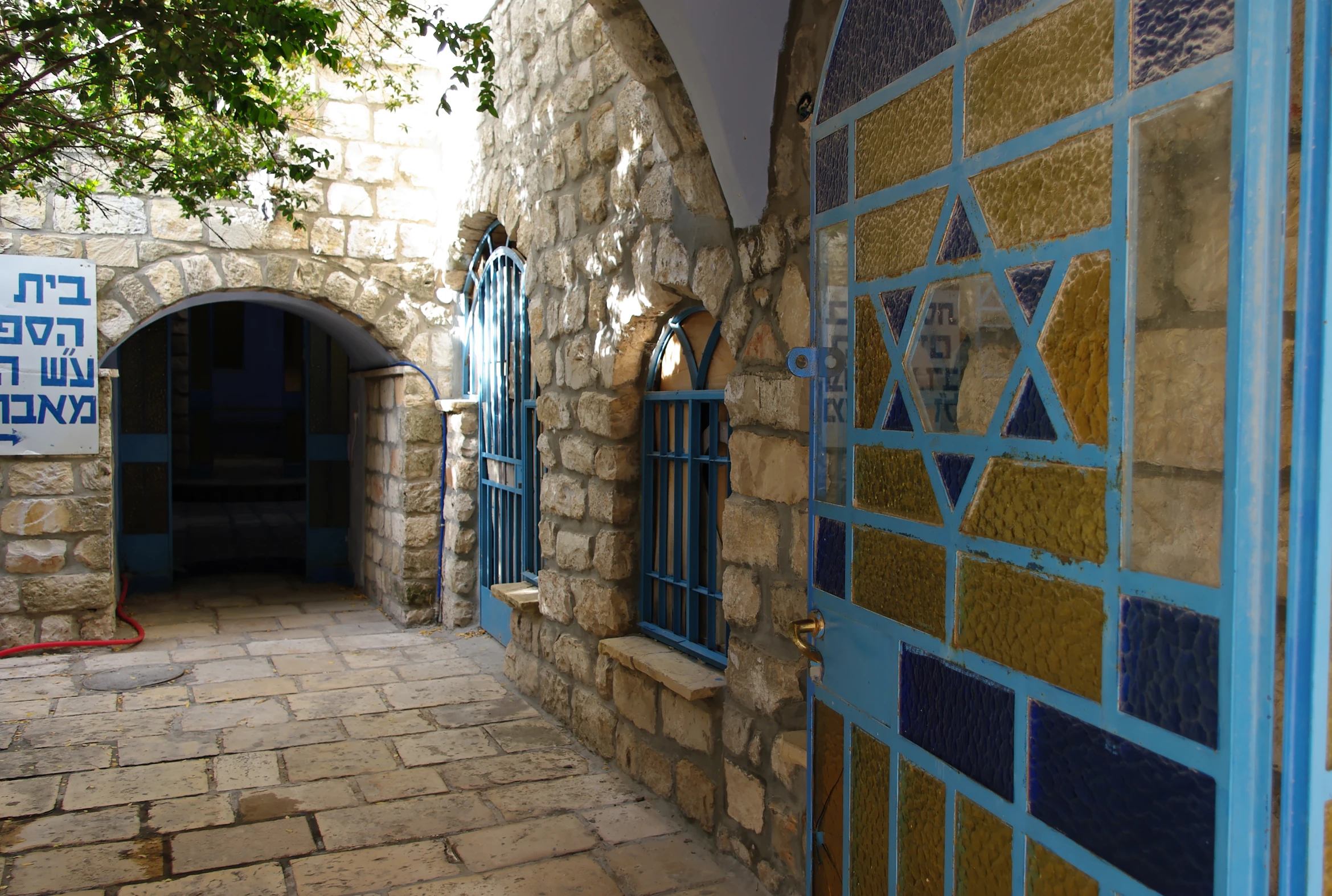 a blue and yellow building on a sidewalk