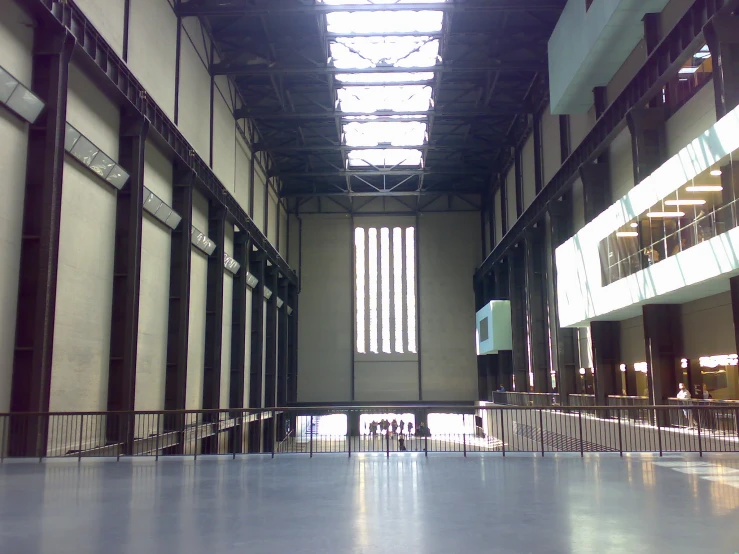 an empty hall with several people standing near one another