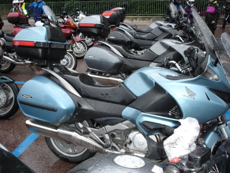 many motorcycles are lined up in a parking lot