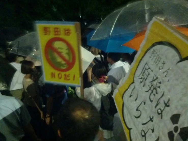 many people holding signs in various languages