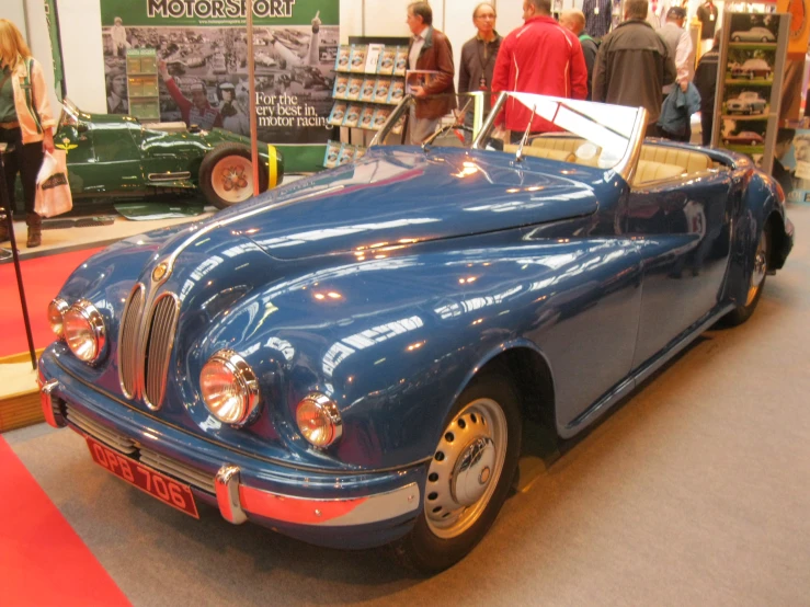 blue classic sports car in display at show