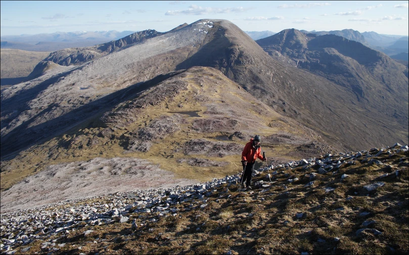 a man is standing in the mountains hiking