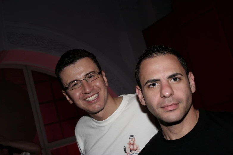 two males with glasses posing for the camera