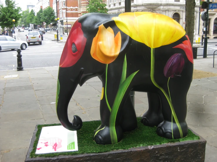 a statue of a black elephant on the ground
