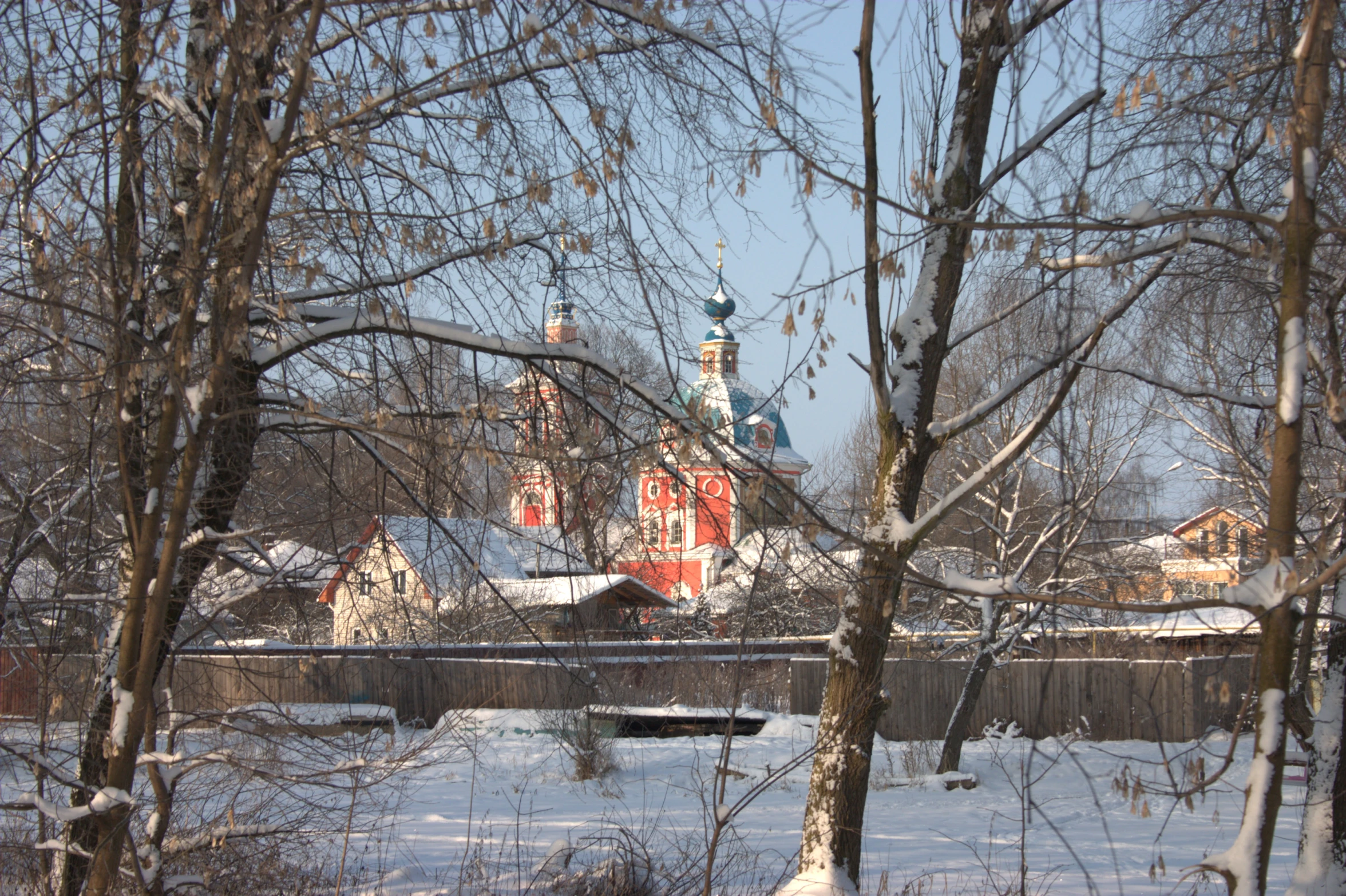 a large, red house surrounded by lots of trees