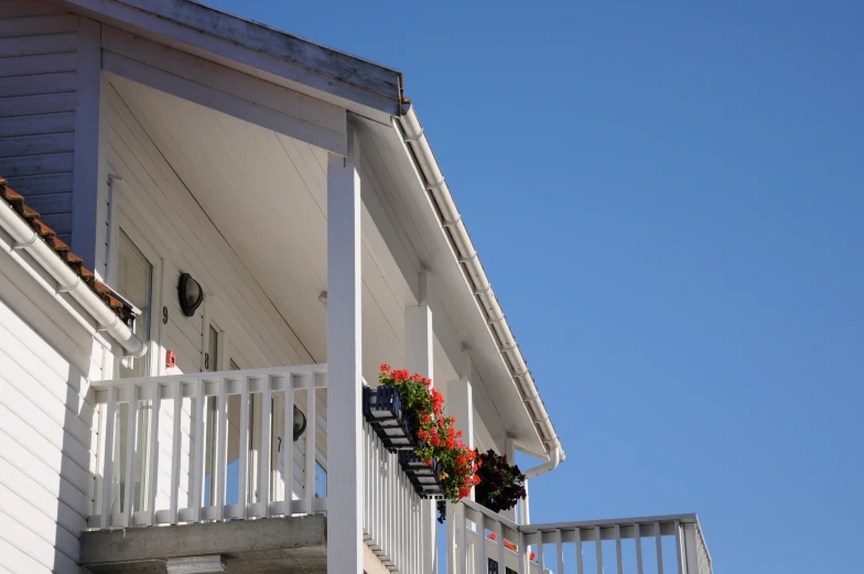 a house with a balcony and flower boxes on it