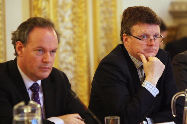 three business people sitting down at a table