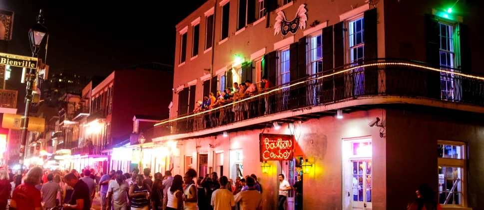 a crowded city street is lit up at night with neon