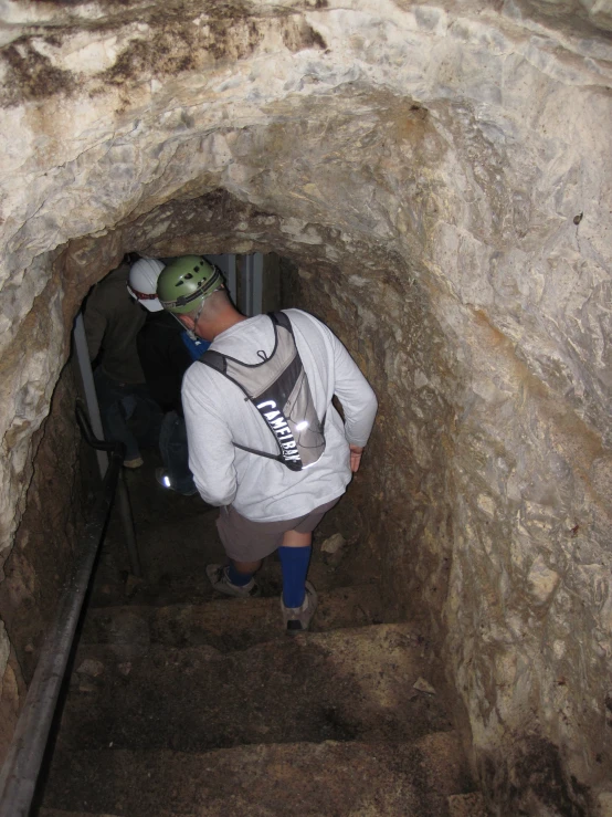 a man standing in the middle of an under tunnel