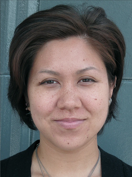a woman wearing a black cardigan sweater and necklace